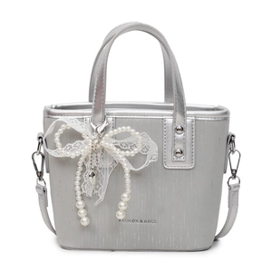 Silver bucket bag for women with pearl bow decoration and lace detail on white background