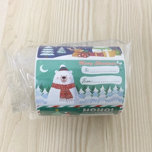 Detail of Christmas gift labels with polar bear and reindeer motifs on a sticker roll