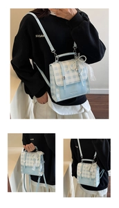 Detail of blue plaid backpack featuring pearl lace bow charm and adjustable straps