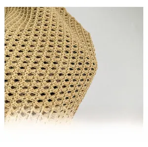 Close-up of the delicate woven texture and hollow pattern of this straw tote bag