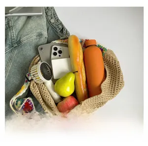 Top-down view of large beige woven tote bag showing spacious capacity and floral strap