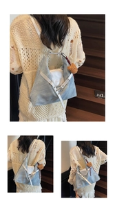 Detail of light blue denim and silver leather backpack with metal chain and bear charm