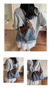 Blue canvas tote bag with brown leather straps and cute plush bear charm detail
