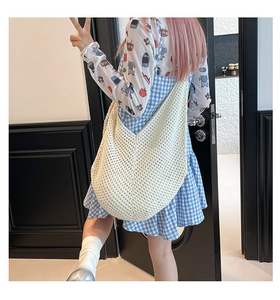 Detailed view of cream crochet tote bag featuring hollow knit design and large capacity