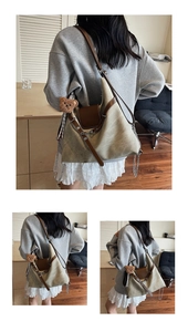 Detail of vintage khaki canvas backpack with brown leather trim and bear charm accessory