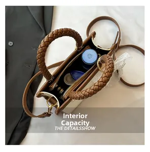 Top view of the interior capacity of a vintage two-tone crossbody bag with items inside