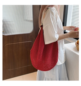 Detail of red hollow-out crochet beach bag with colorful embroidered shoulder strap