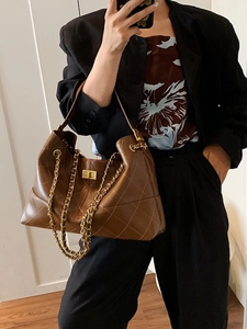 Quilted caramel brown tote bag with gold chain strap and metallic twist-lock closure