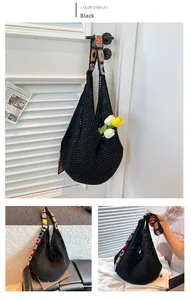 Detail of black hollow crochet tote bag with colorful floral knit shoulder straps
