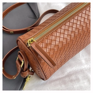 Detail einer braunen geflochtenen Leder-Boston-Tasche mit goldenem Reißverschluss