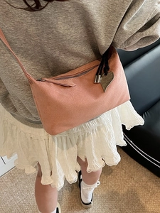 Pink suede shoulder bag with silver hardware and heart charm pendant for women