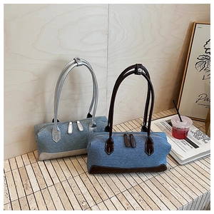 Close-up of vintage denim handbags with leather trim and dual zipper detail