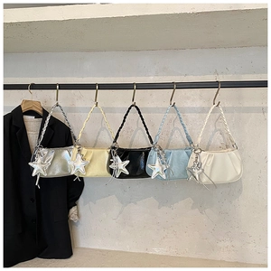 Detail of colorful pleated cloud bags with woven handles and star pendants hanging in a row