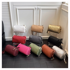 Detailed grid display of cylindrical woven leather crossbody bags in eleven vibrant colors