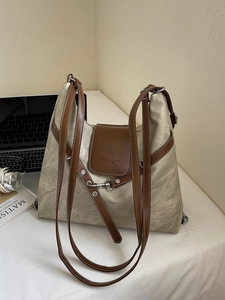 Large color-block canvas tote backpack with brown leather straps for commuting