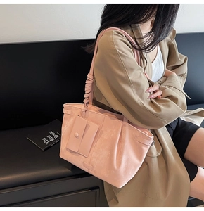 Bolso tote rosa grande con bandolera y vista lateral en modelo para el uso diario