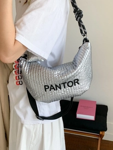 Silver quilted crescent shoulder bag with metallic finish and braided strap for women