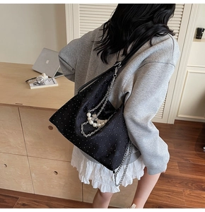 Chic black polka dot shoulder bag with silver chain and pearl strap details
