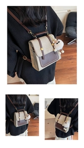Macro detail of canvas texture with leather straps and plush charm on vintage backpack