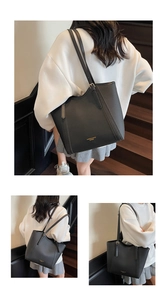 Détail du sac cabas en cuir grainé noir avec ferrures dorées et bandoulière double