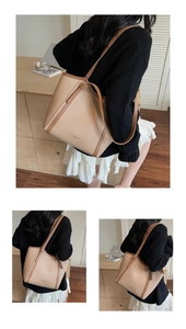 Détail du grand sac cabas bicolore avec texture grainée et logo doré élégant