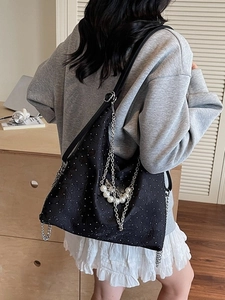 Large black denim tote bag featuring silver chains, pearls and butterfly charm decoration
