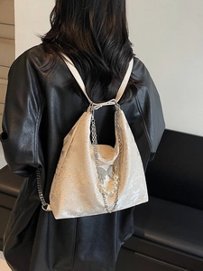 Off-white jacquard backpack with butterfly patterns and pearl chain shown on model