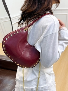 Burgundy crescent moon hobo bag with gold rivet accents and stylish chain shoulder strap