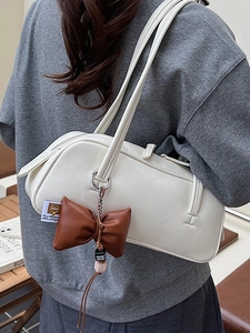 Chic white leather shoulder bag for women with brown bow charm and long straps