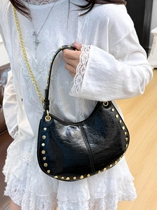 Fashionable black crescent shoulder bag with gold studs and metal chain strap for women