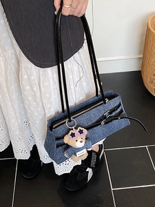 Blue denim shoulder bag with leather straps and cute bear pendant for daily commute