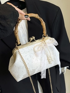 Elegant white lace evening bag with bamboo handle, pearl bow, and gold chain strap