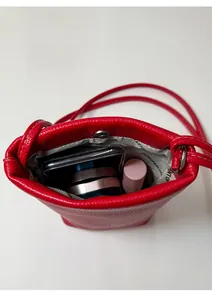 Red lychee grain leather mini tote bag interior showing capacity for phone and cosmetics