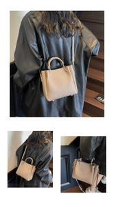 Detail view of lychee pattern leather shoulder bag with gold hardware and logo