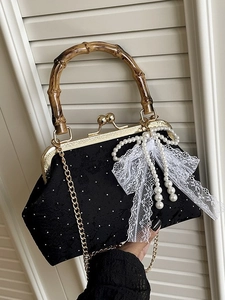 Elegant black jacquard evening bag with pearl bow, bamboo handle and gold chain strap