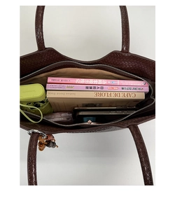 Top view of woven tote bag interior showing large capacity for books and umbrella