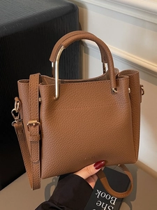 Brown litchi leather tote bag with metal handle and adjustable strap for women