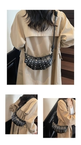 Detail of black crescent moon bag featuring silver studs and knotted shoulder strap