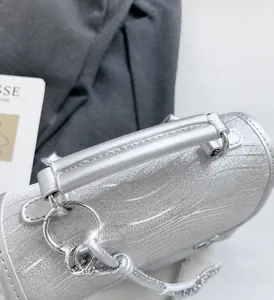 Detail of silver glitter backpack with wave texture, comfortable handle and metal rings
