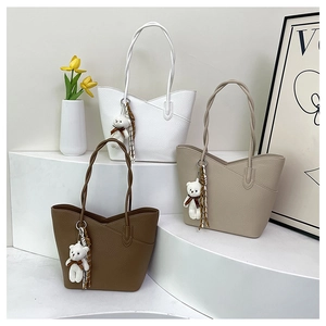 Detailed display of vintage tote bags with braided rope handles and cute bear charms