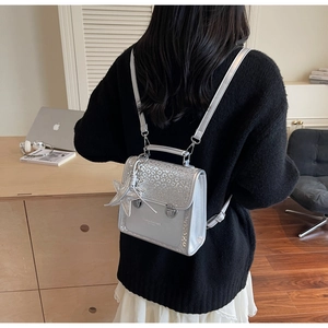 Close-up of silver sequined backpack with leopard print flap and star-shaped pendant
