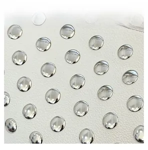 Detailed macro view of white pebble leather texture and polished silver metal rivets
