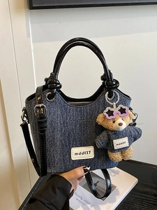 Contrast denim bucket bag with leather strap and cute bear pendant accessory