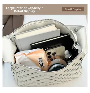 Spacious interior of white studded handbag showing books and makeup capacity