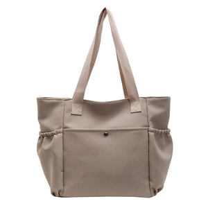 Large capacity canvas tote bag with front snap pocket and elastic side pockets in taupe