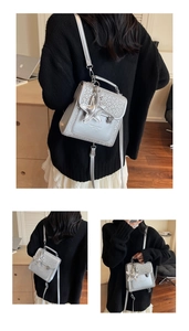 Detail of silver mini backpack with leopard print trim and star charm accessory