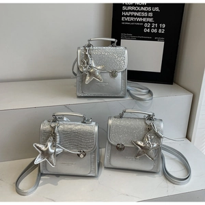 Detail view of silver sequin mini backpacks with starfish charms and stylish textures