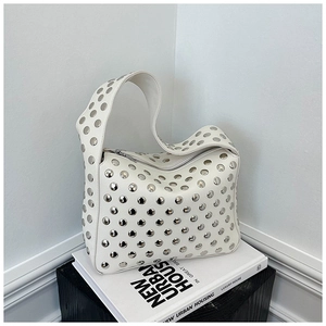 Detail of white lychee leather hobo bag with large silver rivets and zipper