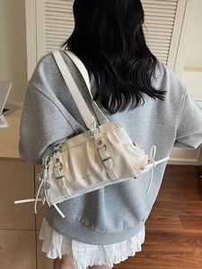 Ruched white glossy shoulder bag with silver buckle straps and star charm detail