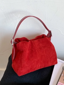 Vintage burgundy matte leather bucket bag with top handle and spacious commuter design
